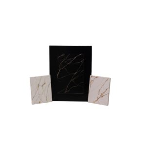 Left: a white slab with gold and silver marbling. Middle: a black door with gold marbling on the panel. Right: A white slab with gold marbling.