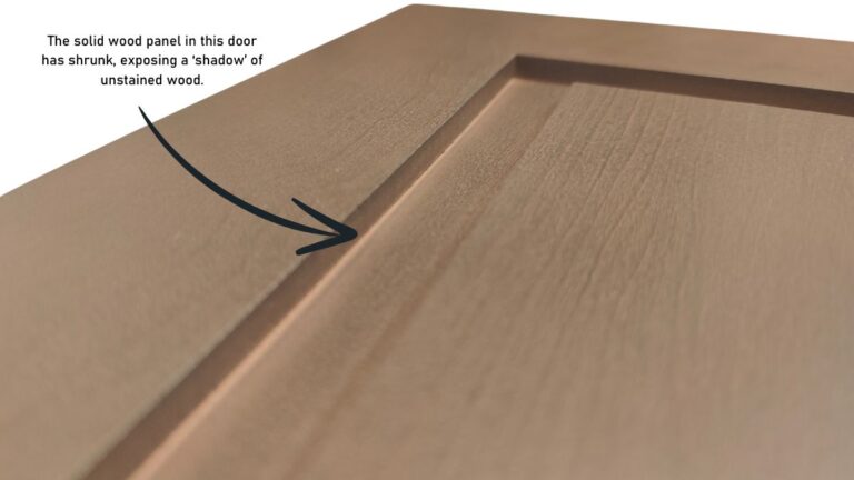 A picture showing a stained panel with exposed wood due to shrinking.