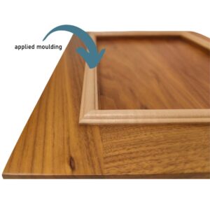 A picture of a Walnut cabinet door with a Maple applied moulding.