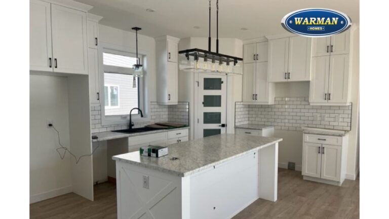 A white painted kitchen with a custom 1 piece MDF cabinet door on the end of the island.