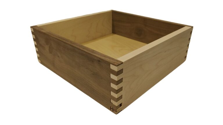 A box joint drawer box with Walnut sides and a Maple front and back.