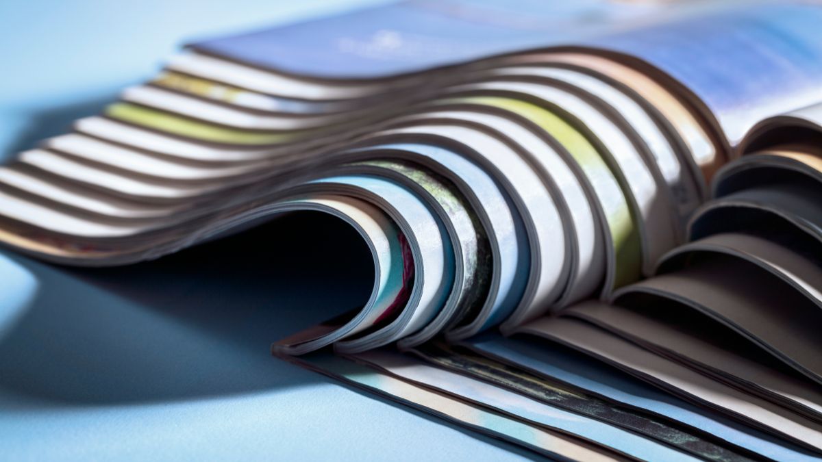 A stack of magazines on a blue background.