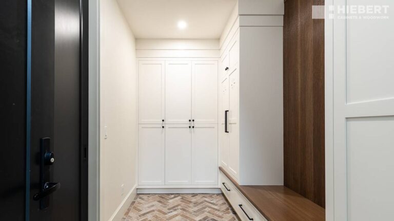 Paint-grade wood cabinet doors work well in high-use areas, like the entryway in this picture.