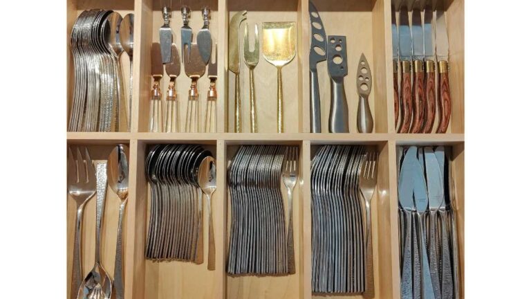 An overhead view of a drawer organizer containing silverware.