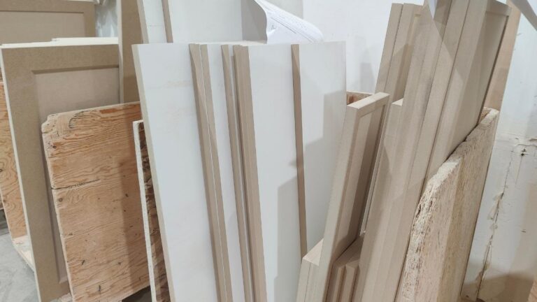 A cart of 1-piece MDF doors with melamine backing. The front (machined) side is raw MDF while the back (flat side) is covered with melamine.