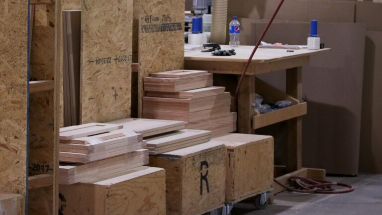 Stacks of plywood panel cabinet doors ready for packing.