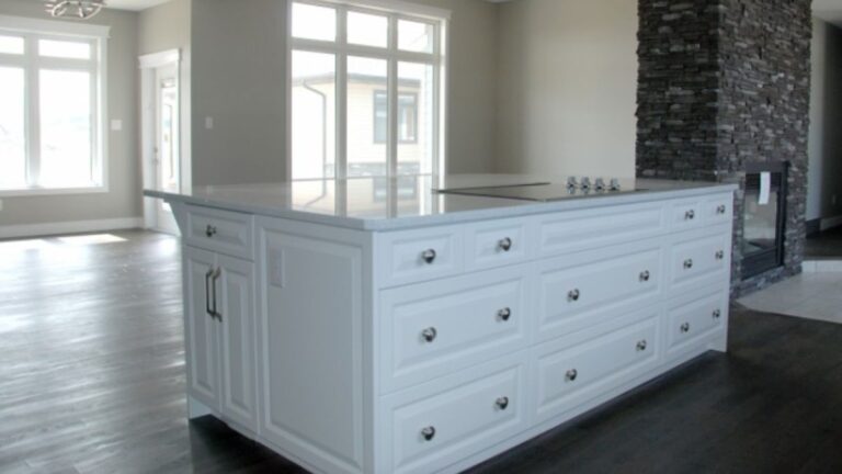 A kitchen island with white raised panel cabinet doors.