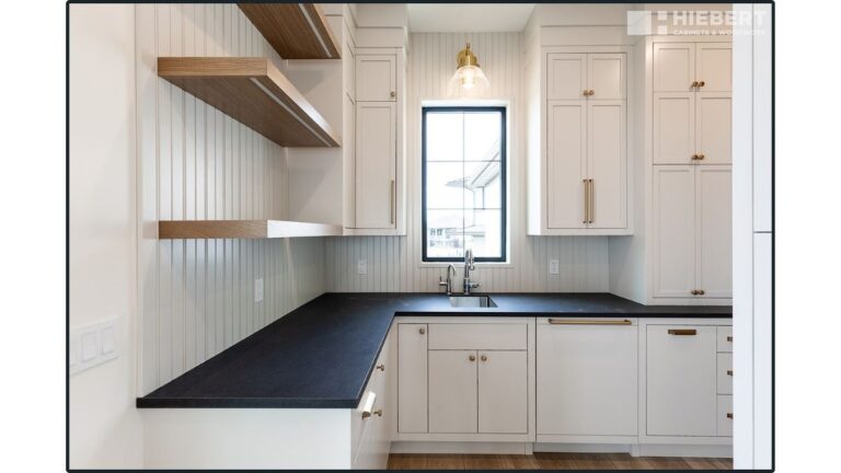 A contemporary pantry featuring white painted 5-piece cabinet doors on the uppers and slab drawer fronts and doors on the lowers.