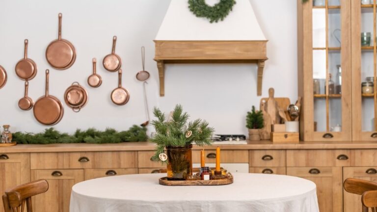 A kitchen with a Christmas-themed centrepiece on the table. Custom cabinet doors and a range hood are visible in the background. You should order custom pieces like range hoods 4-6 weeks in advance.