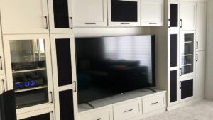 An entertainment centre with white painted cabinet doors. Armstrong Painting & Renovation works with homeowners in Edmonton.