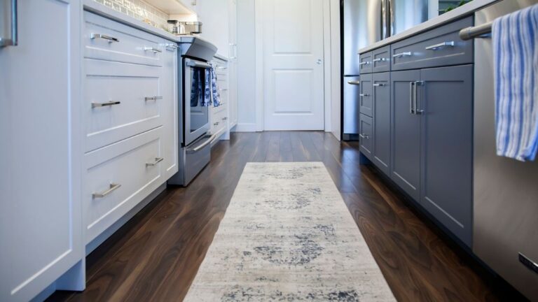 A kitchen with painted MDF cabinet doors - white painted doors along the perimeter and blue painted cabinet doors on the island.