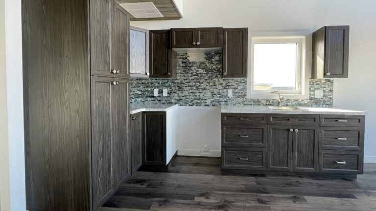 A kitchen with dark-brown woodgrain NEXGEN cabinet doors and silver hardware. The quantity of material Cutting Edge has in stock can extend the lead time.