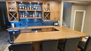 A kitchen with clear lacquer wood cabinet doors and butcher block counter tops. Caliber Cabinet Solutions works with homeowners in Moose Jaw.