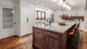 A kitchen with a combination of white painted and Walnut cabinet doors. Chris Murray Custom Cabinets works with homeowners in Regina.