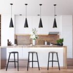 A kitchen featuring matte white slab cabinet doors with wood accents and countertops.