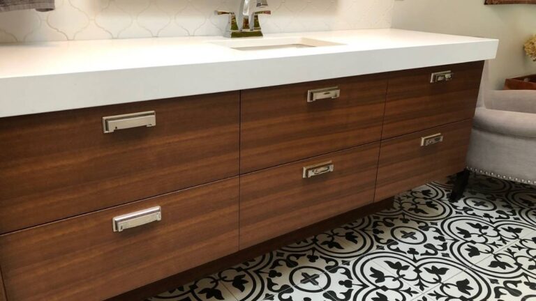 A sink cabinet featuring grain matched slab drawer fronts. It is much easier to grain match veneer slab cabinet doors than solid wood slabs.