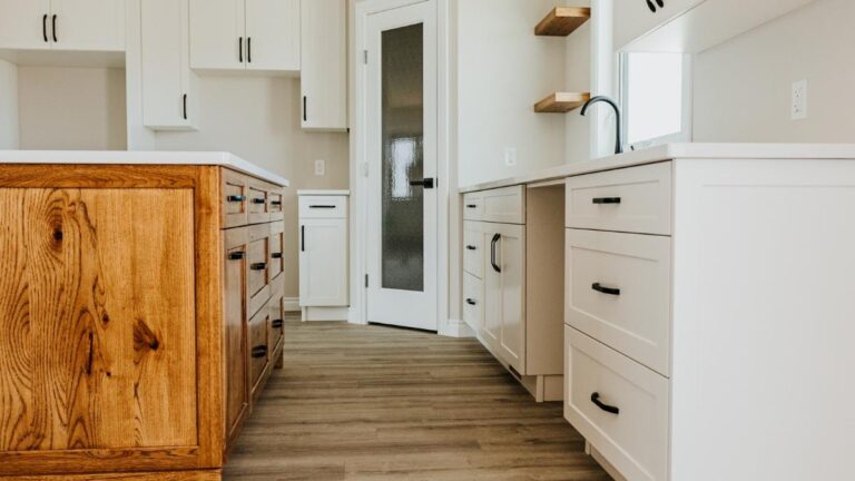 Often, contractors or cabinet makers use thermofoil cabinet doors as a less-expensive alternative to painted cabinet doors. This kitchen features white thermofoil doors with Knotty Hickory cabinet doors on the island.