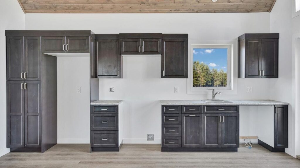 A kitchen with dark-grey stained cabinet doors. Using a spray stain finish usually results in a more consistent appearance.