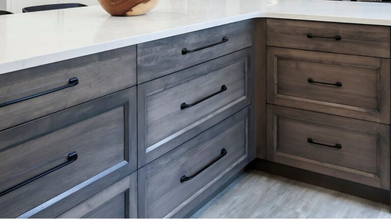 Using a wiping stain, like the stain used on these grey cabinet drawer fronts, can result in colour variation between pieces as it reacts differently to the wood used.