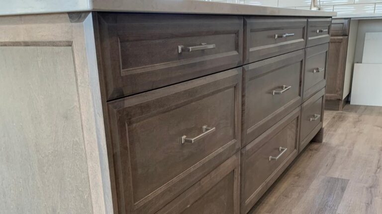 Using a wiping stain finish, like the finish used on these grey-stained cabinet doors, helps prevent unfinished wood showing up over time.