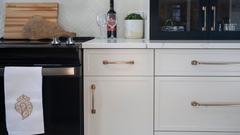 A kitchen with white painted slim shaker cabinet doors and brass hardware. You can order three types of slim shaker cabinet doors.