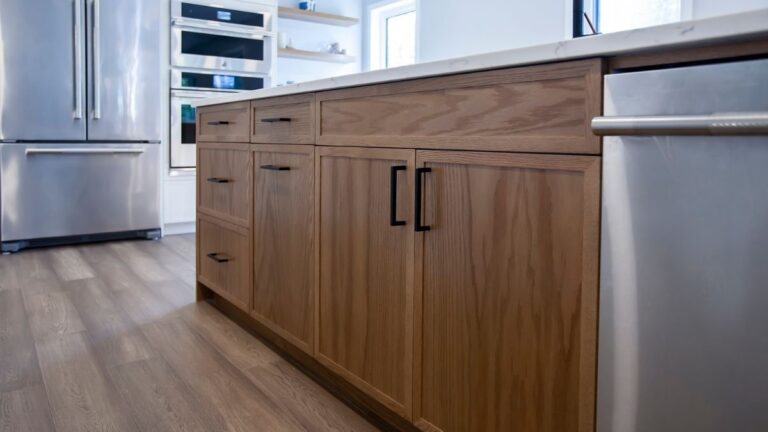 A kitchen with wood mitred slim shaker cabinet doors and black hardware. Mitred slim shaker cabinet doors are reasonably priced and allow you to use standard hardware.