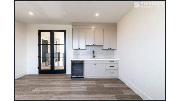 A butler's pantry featuring white painted applied moulding slim shaker cabinet doors. This is the original construction method, and is generally more trusted by cabinet makers and contractors.