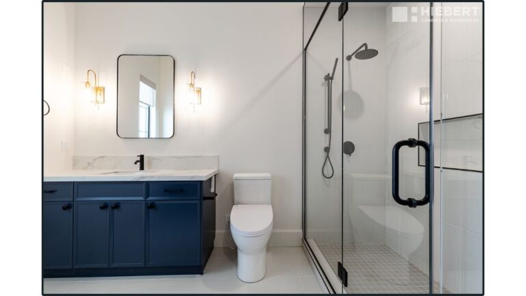 A vanity with blue painted applied moulding slim shaker cabinet doors. While Cutting Edge doesn't recommend painting this door style, you can still do so.