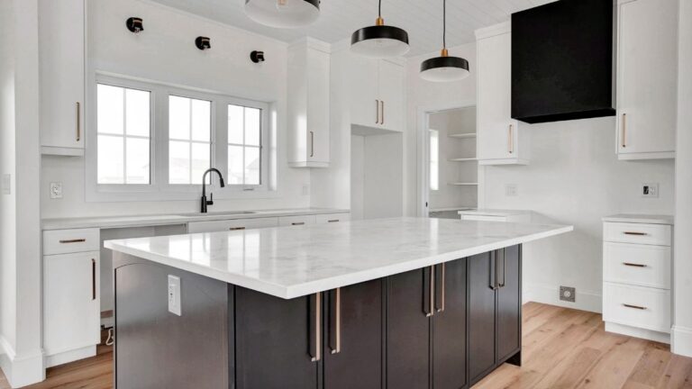 A transitional kitchen with a combination of white painted and stained slim shaker cabinet doors.